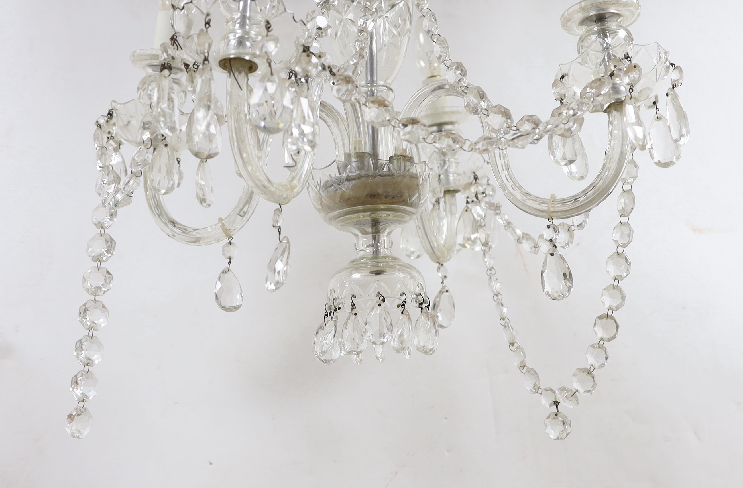 A glass four branch chandelier with hanging drops, 59cm high